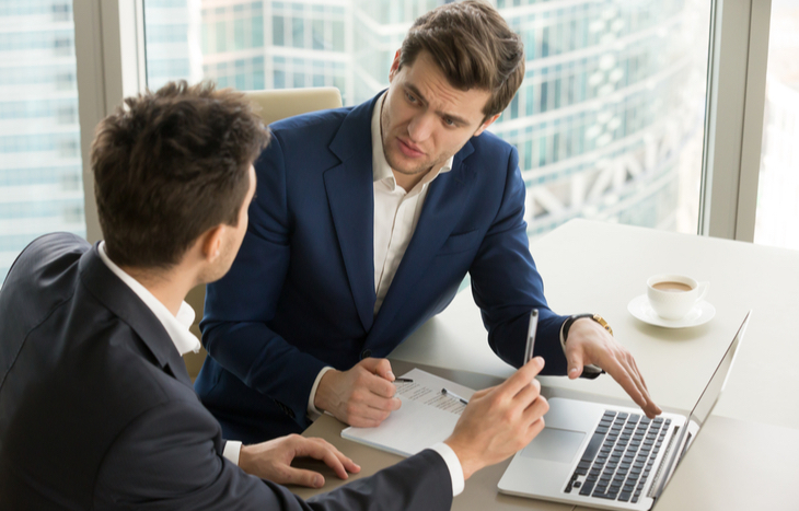 A broker speaks with his client