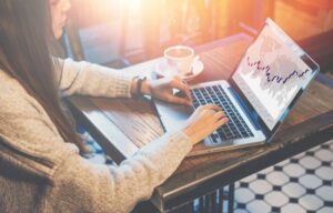 A woman trading put options on her laptop.