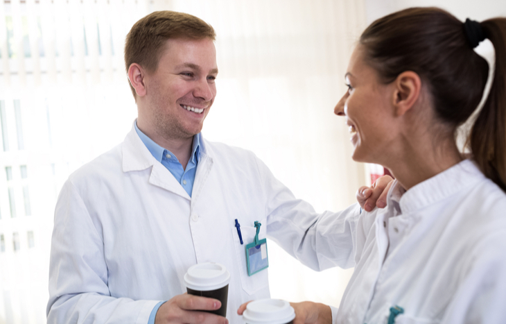 Colleagues discussing the best small cap biotech stocks